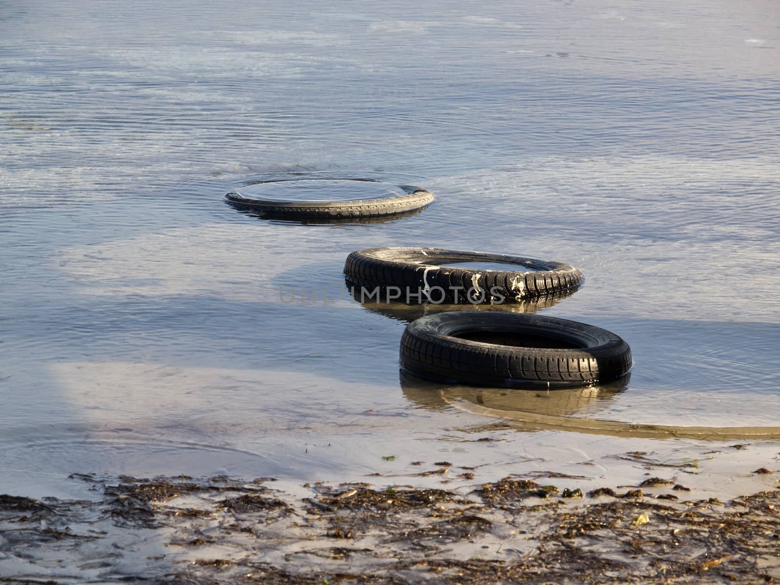 tyres in the water on the coast of the sea