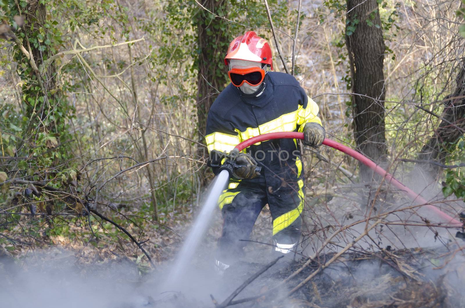 firefighter fighting fire in smoke