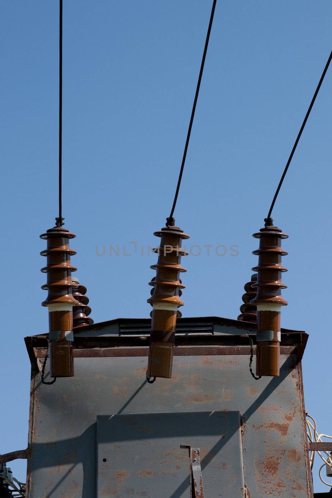 high-voltage wire and insulators on blue sky