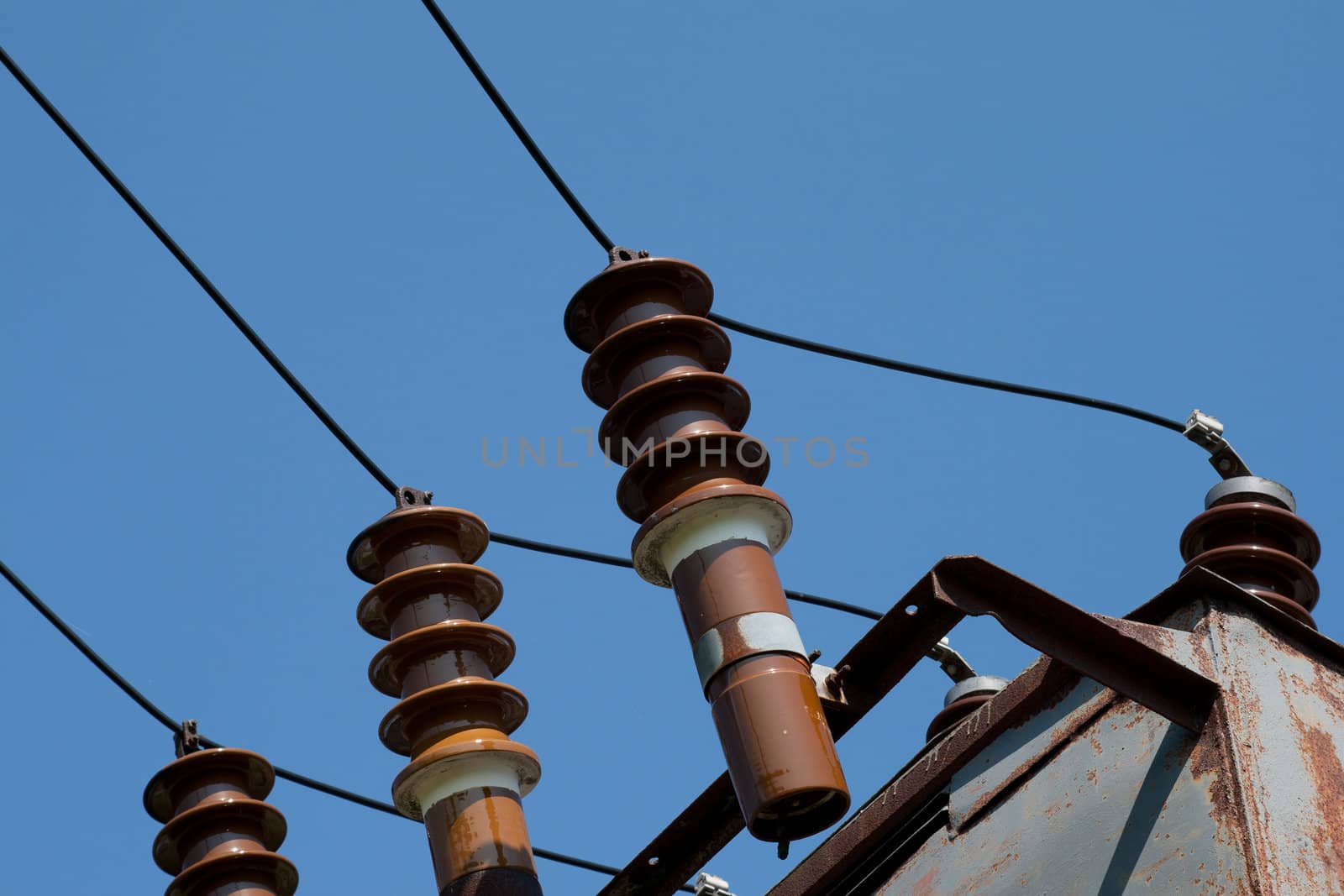 high-voltage wire and insulators on blue sky