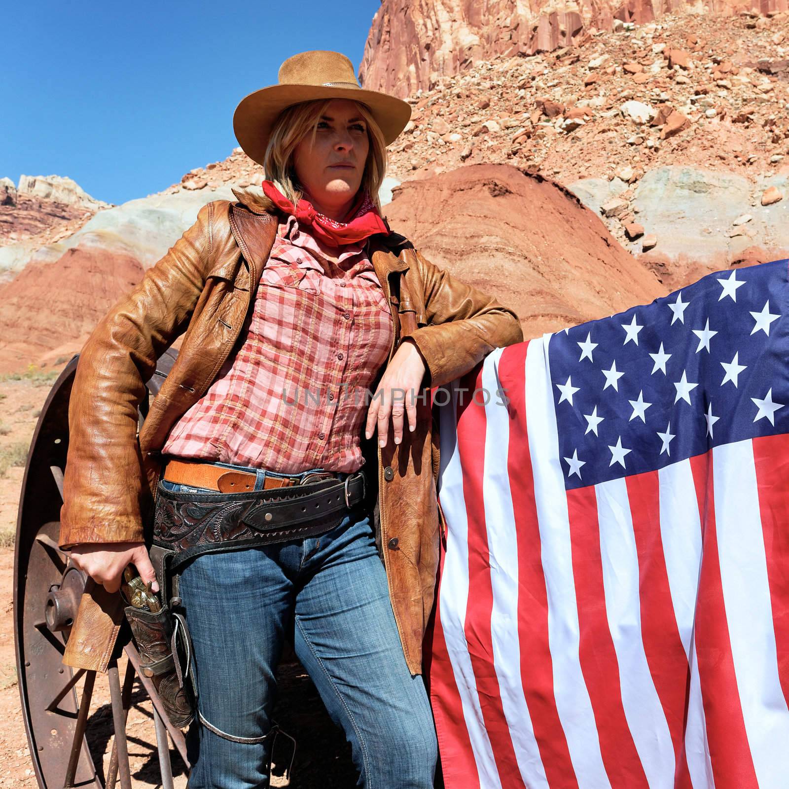 portrait of a blond cowgirl with american flag