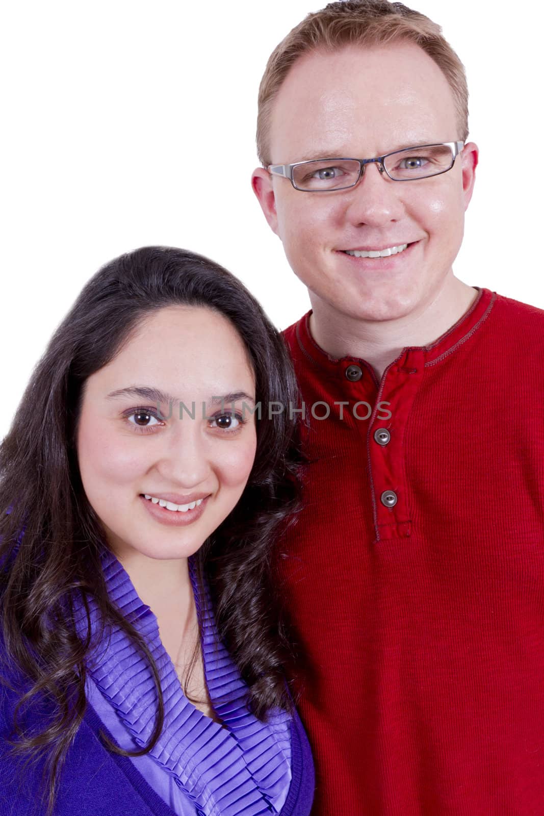 Beautiful Mexican wife and her clean cut American husband looking at camera happily.