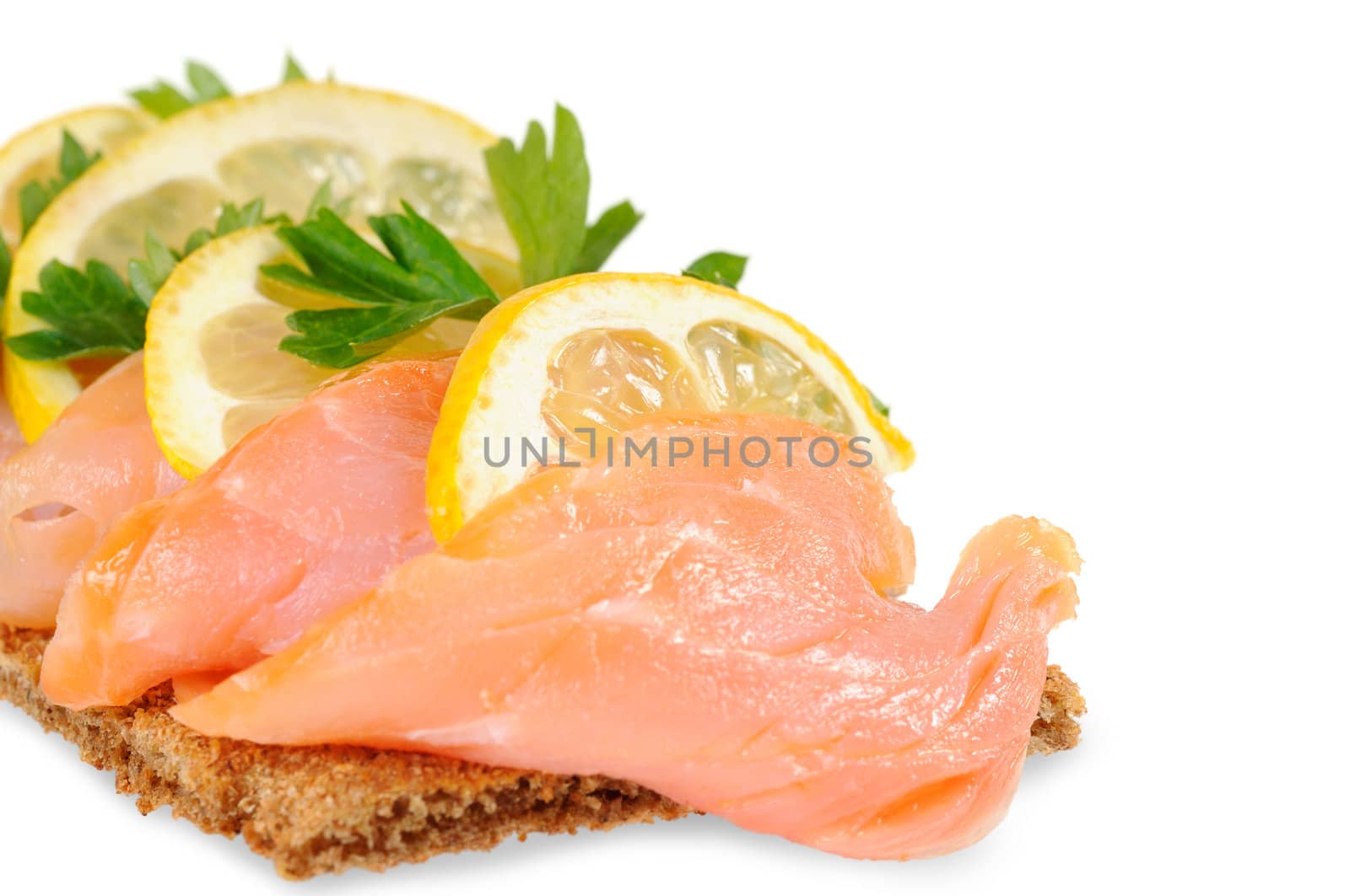 Sandwich snack - salmon with lemon on rye bread. Isolated on white.