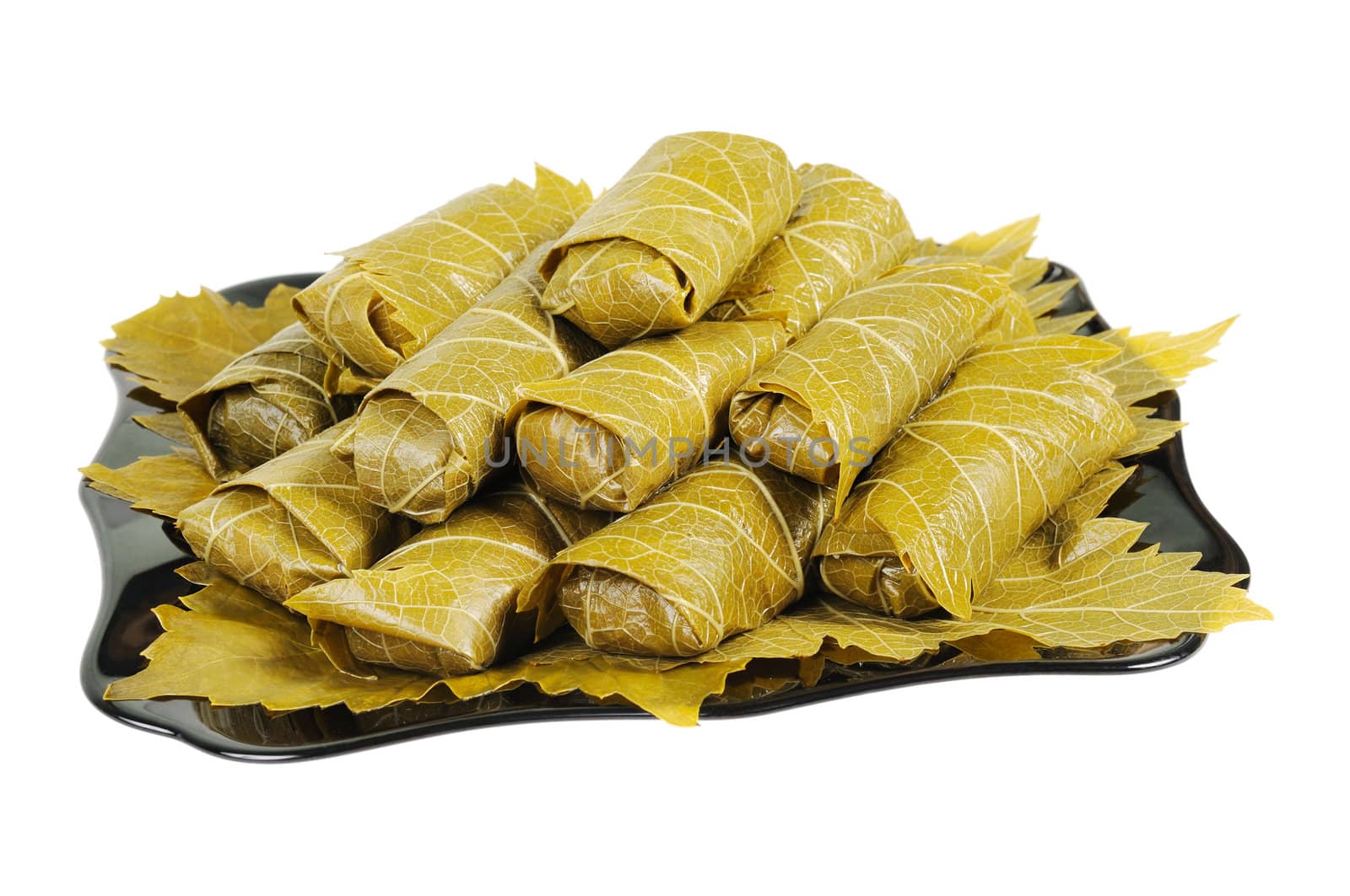 Dolma on a black plate. Isolated on white background.