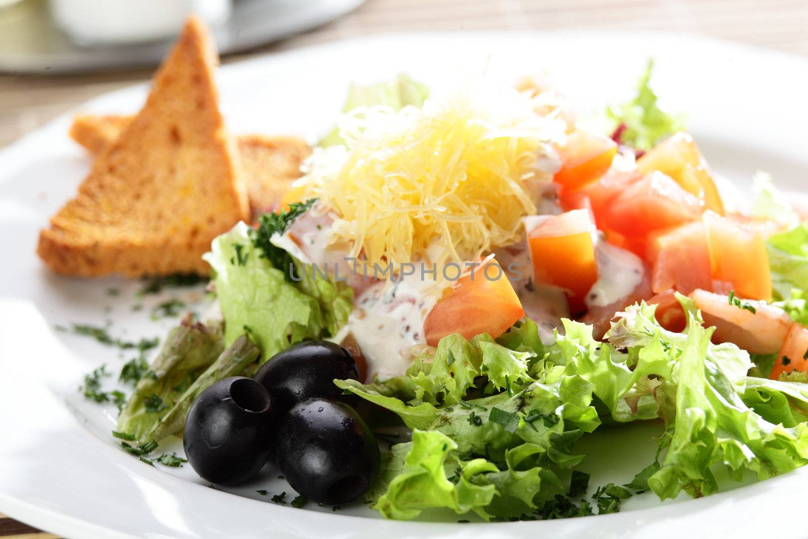 Fresh and tasty salad on the wooden table