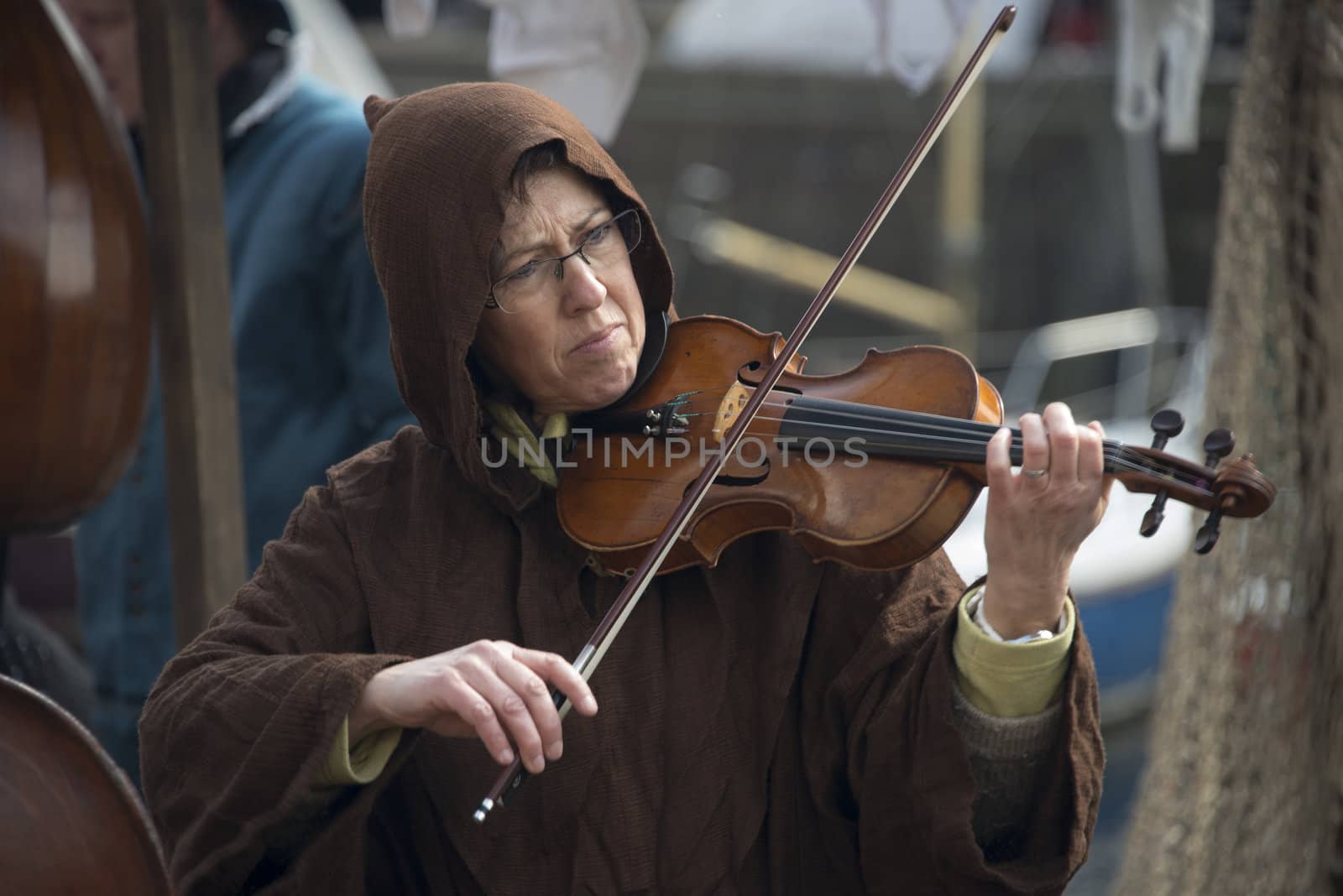 BRIELLE,HOLLAND APRIL 01:Woman in traditional costume playing panflute on the market on April 01, 2013 in Brielle,Holland.This is the party of the point in the uprising of Low Countries against Spain in the 80 Years' War