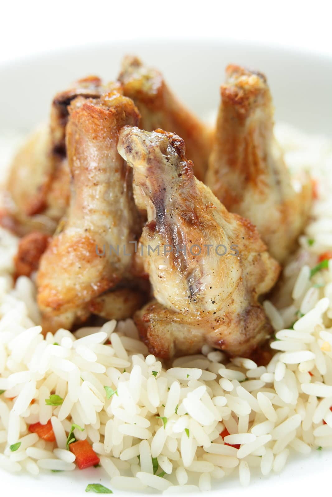 Chicken legs with rise in the white dish