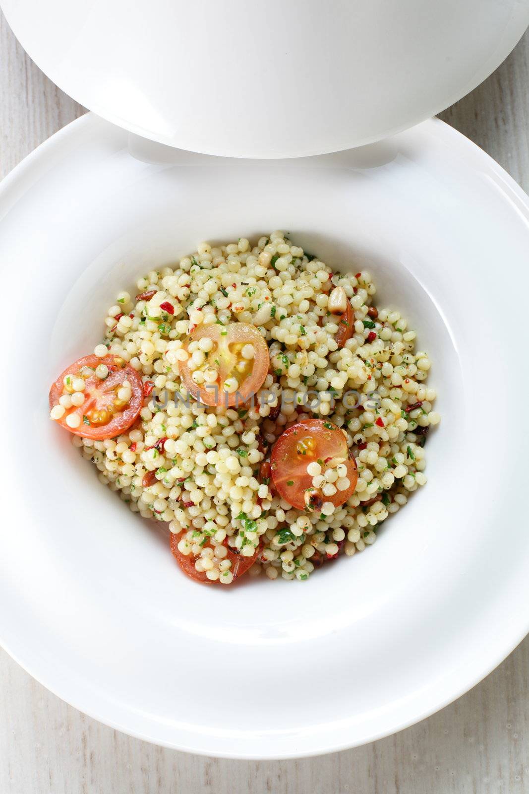 Millet in the white dish on wooden table