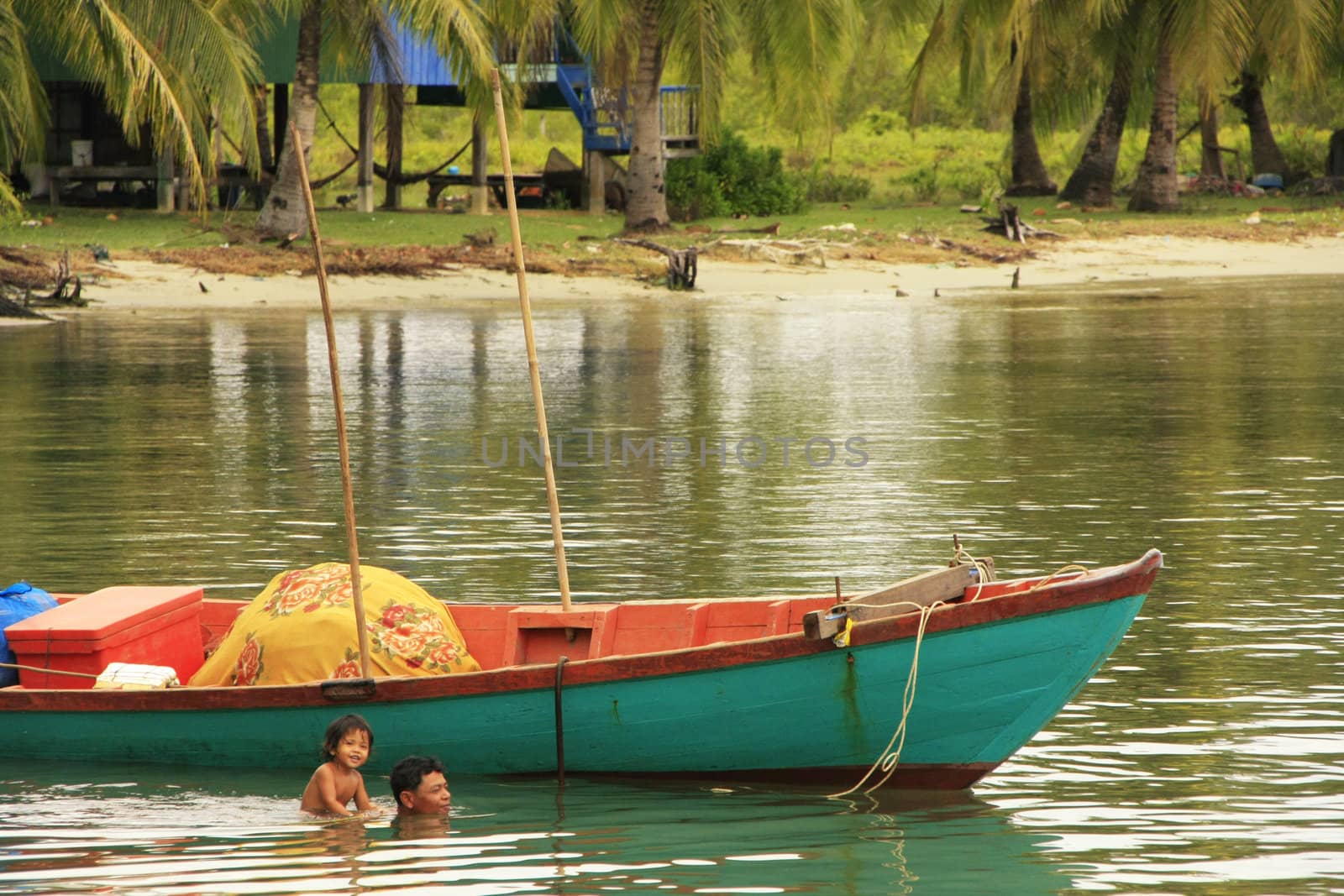 Father and child swimming together, Ream National Park, Cambodia, Southeast Asia