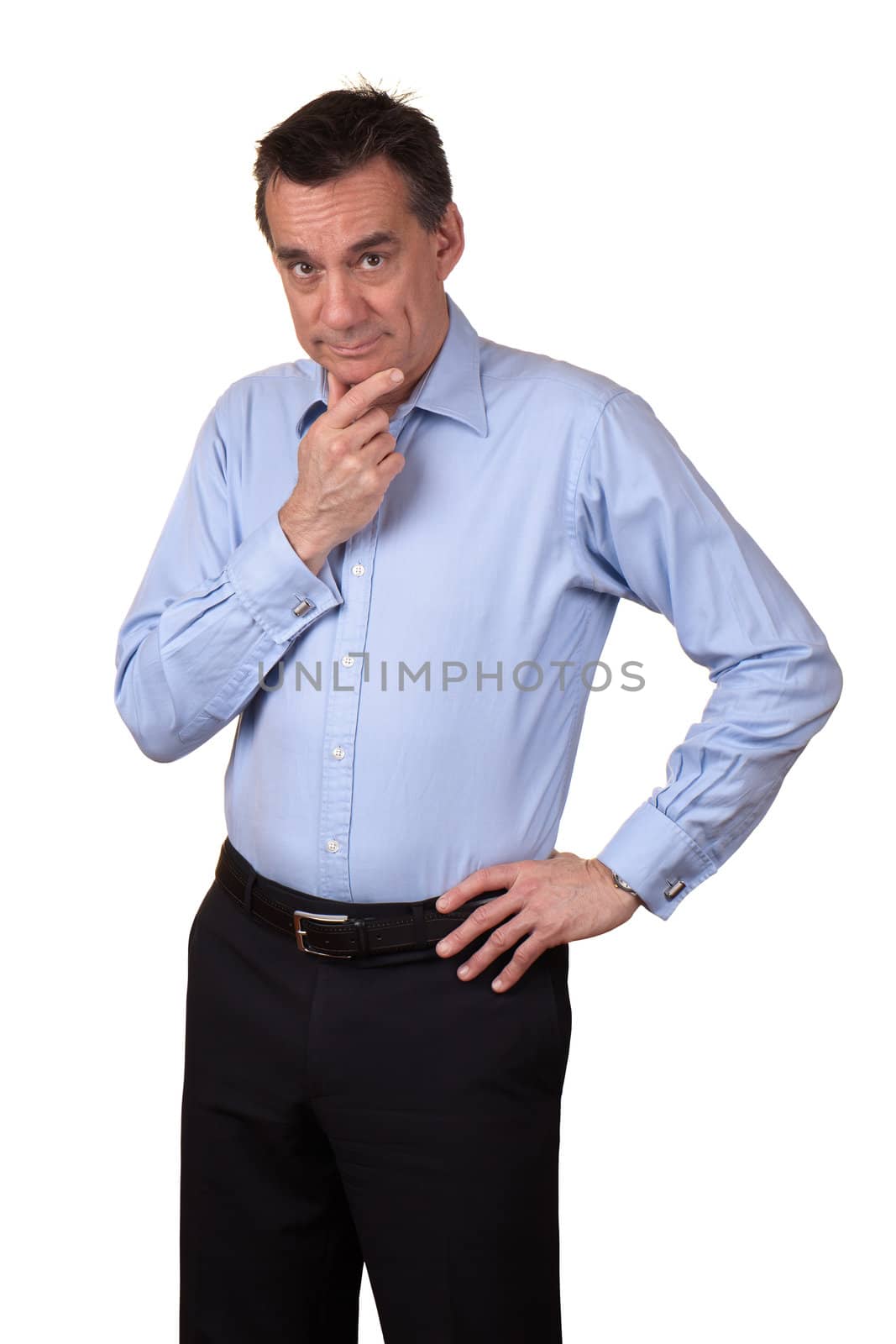 Attractive Middle Age Man in Blue Shirt with Thoughtful Expression and Hand on Hip