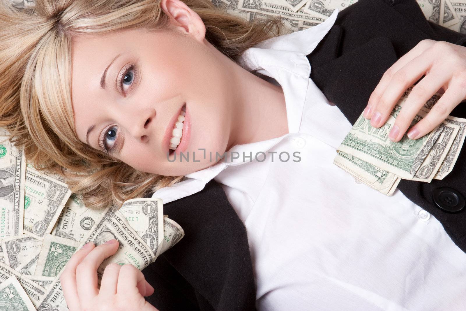 Smiling woman laying in money