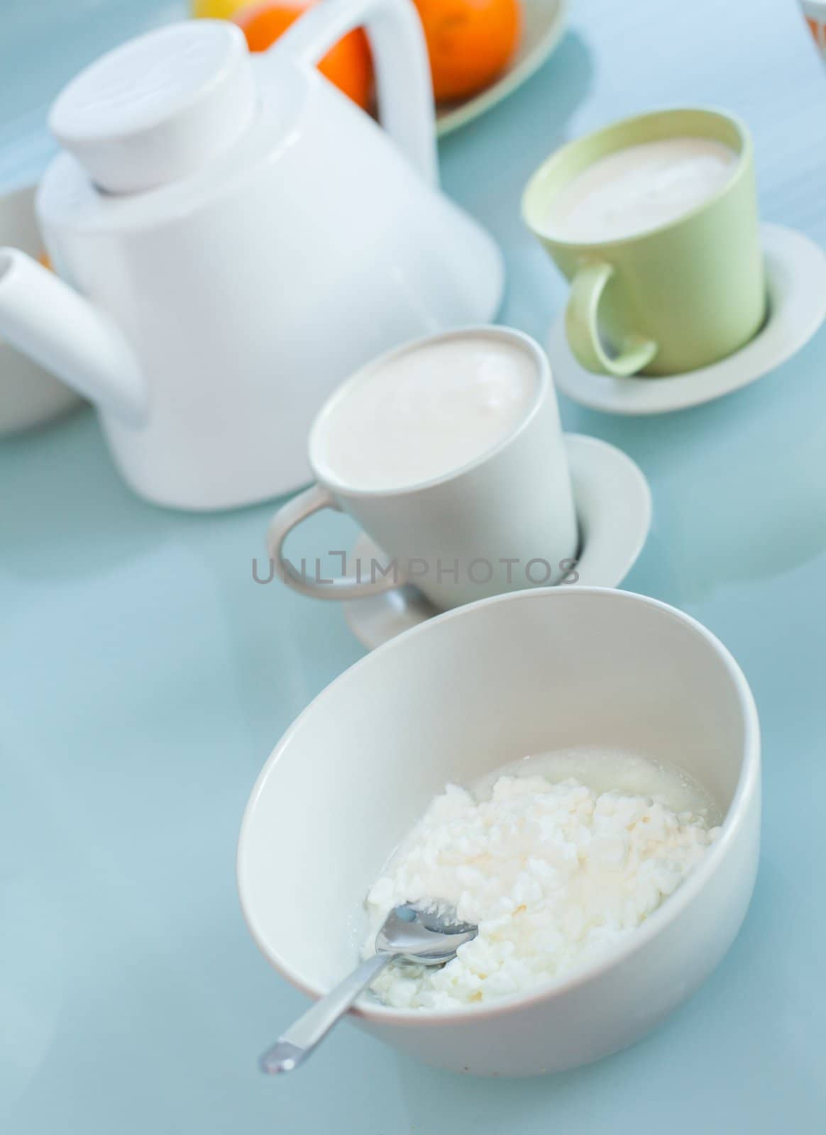 Early health breakfast - milk and cheese, a healthy eating on white plate and cup