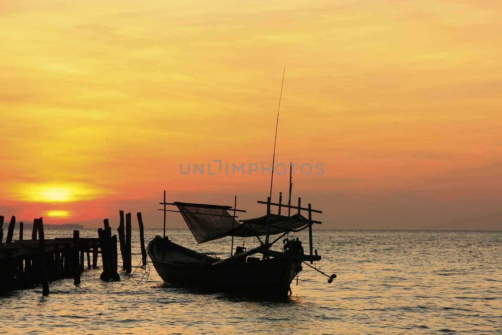 Silhouette of traditional fishing boat at sunrise, Koh Rong island, Cambodia, Southeast Asia