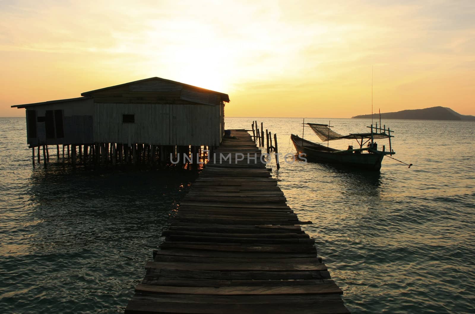 Silhouette of wooden jetty at sunrise, Koh Rong island, Cambodia, Southeast Asia