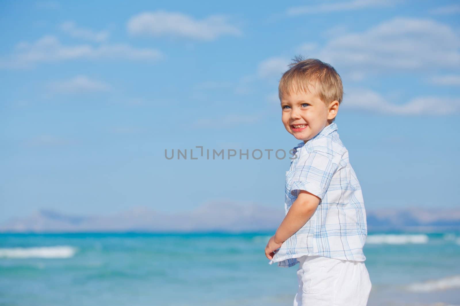 Little cute boy on the beautiful exotic white beach, Mallorca, Spain