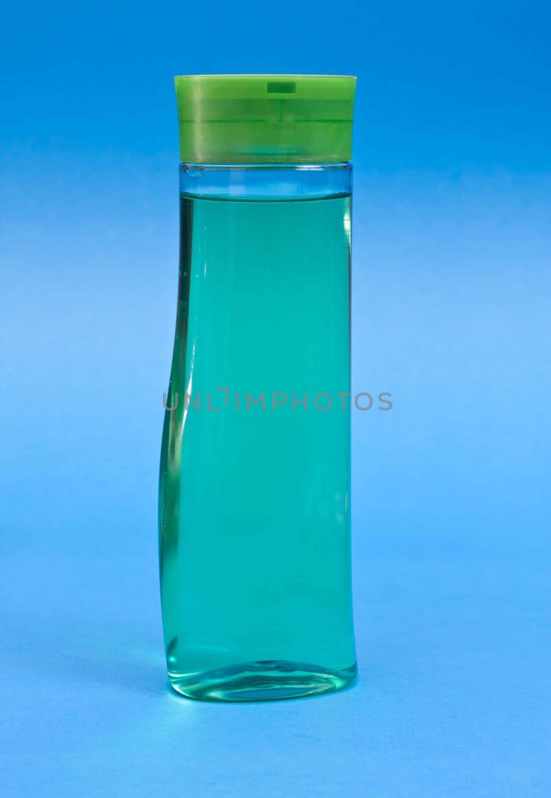 Plastic clean shampoo bottle isolated on a blue background