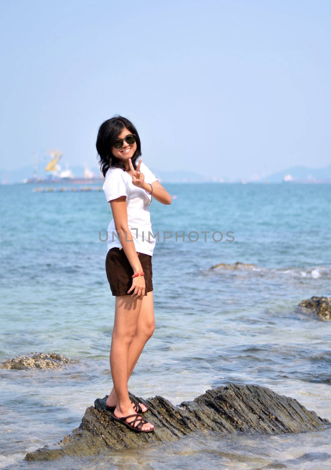 Asian woman on beach summer holiday by siraanamwong