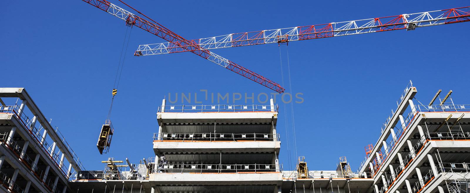 building site with crane and blue sky, panoramic view
