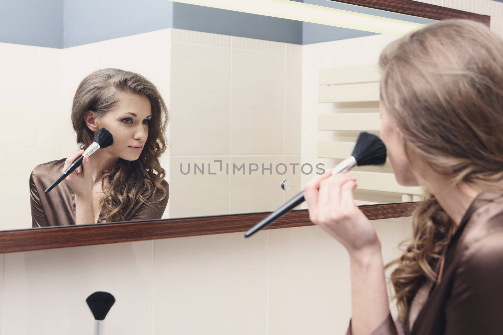 The young beautiful girl does makeup by robert_przybysz