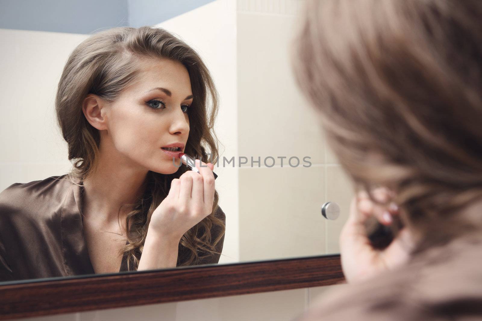 The young beautiful girl does makeup by robert_przybysz
