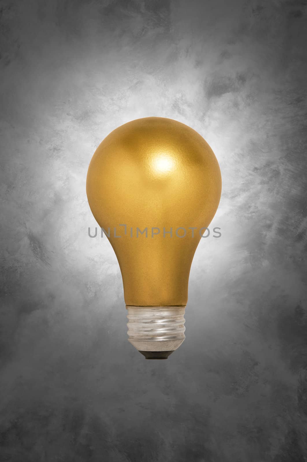 Gold light bulb floating against a gray mottled background