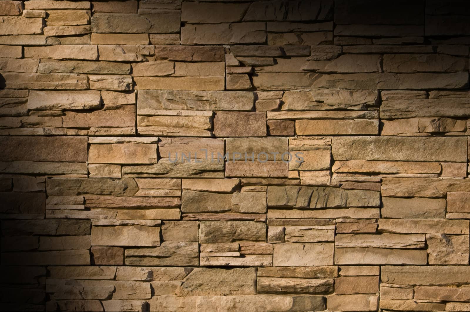 Irregular sized brown bricks with an organic feel, lit diagonally