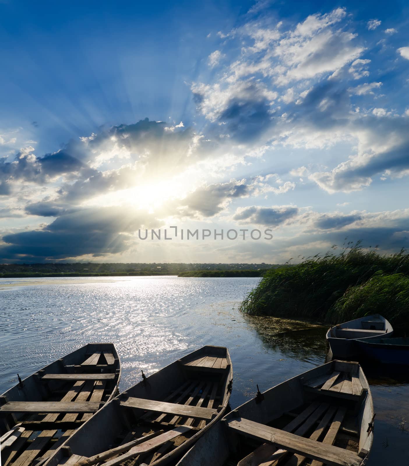 sunset over river with boats by mycola