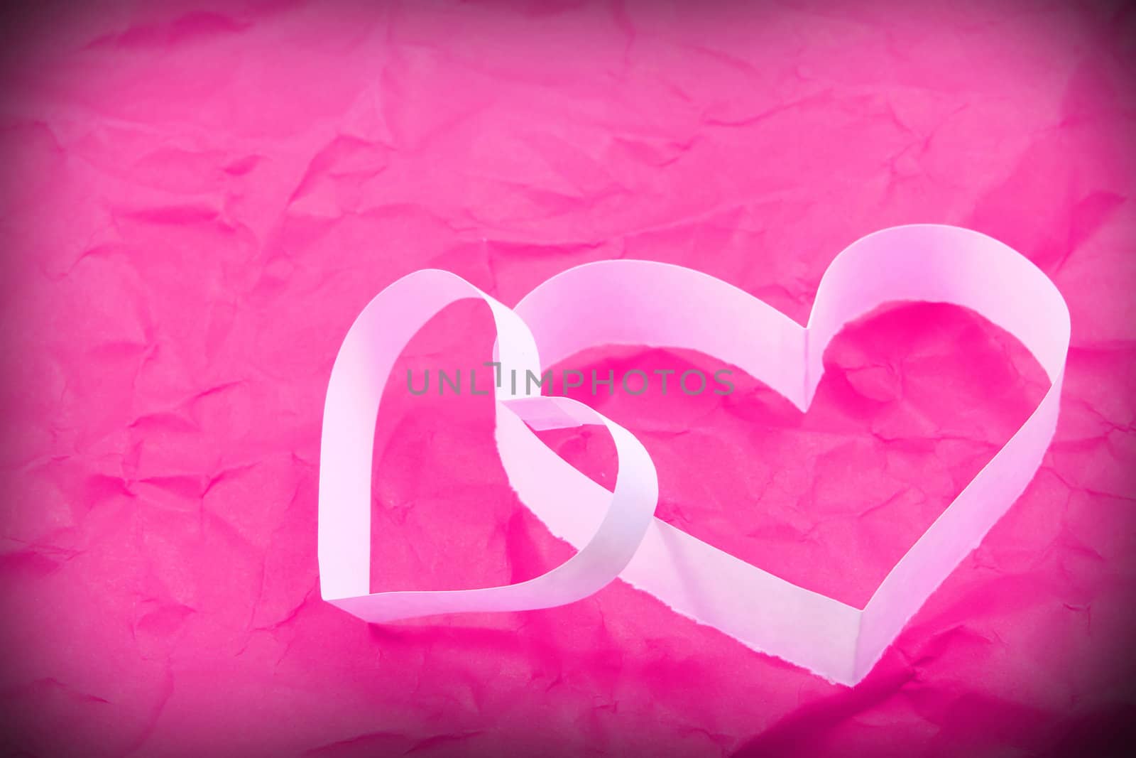 Paper hearts on pink background