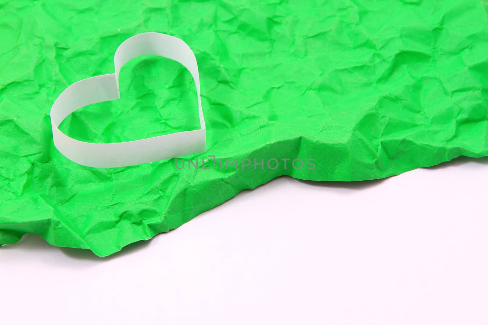 Paper hearts on green background  by rufous