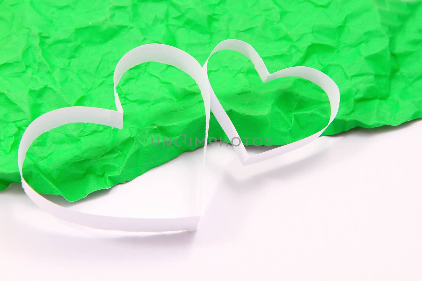 Paper hearts on green background