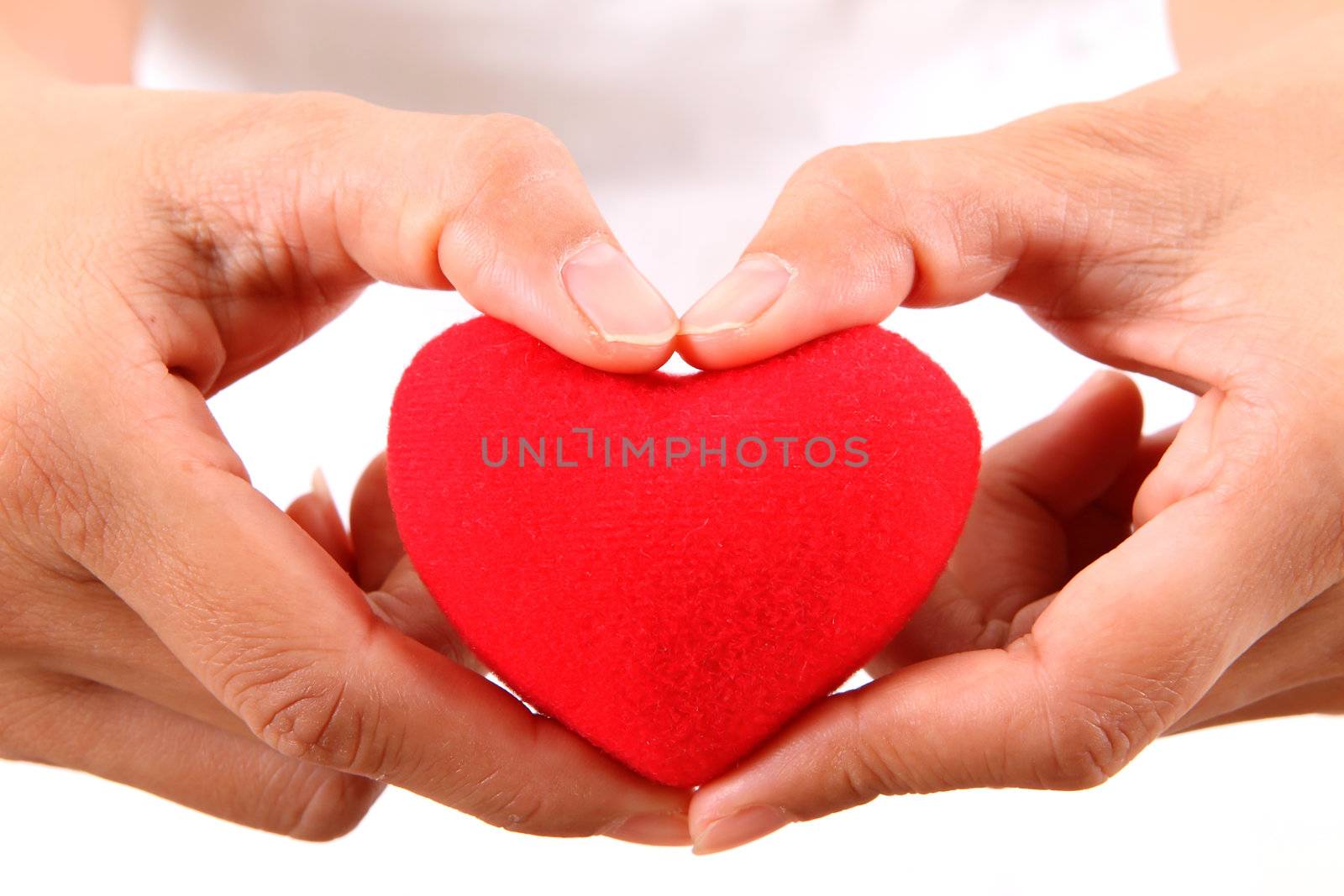 Female hands with red heart