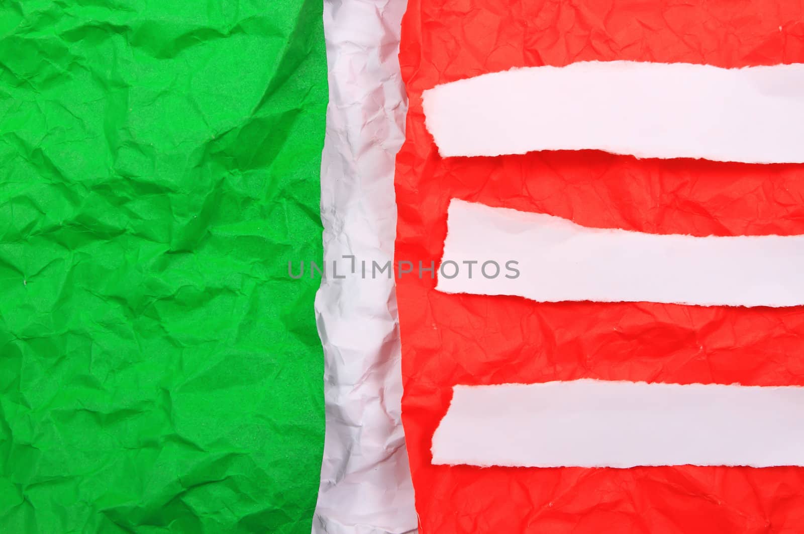 Green torn paper on red paper