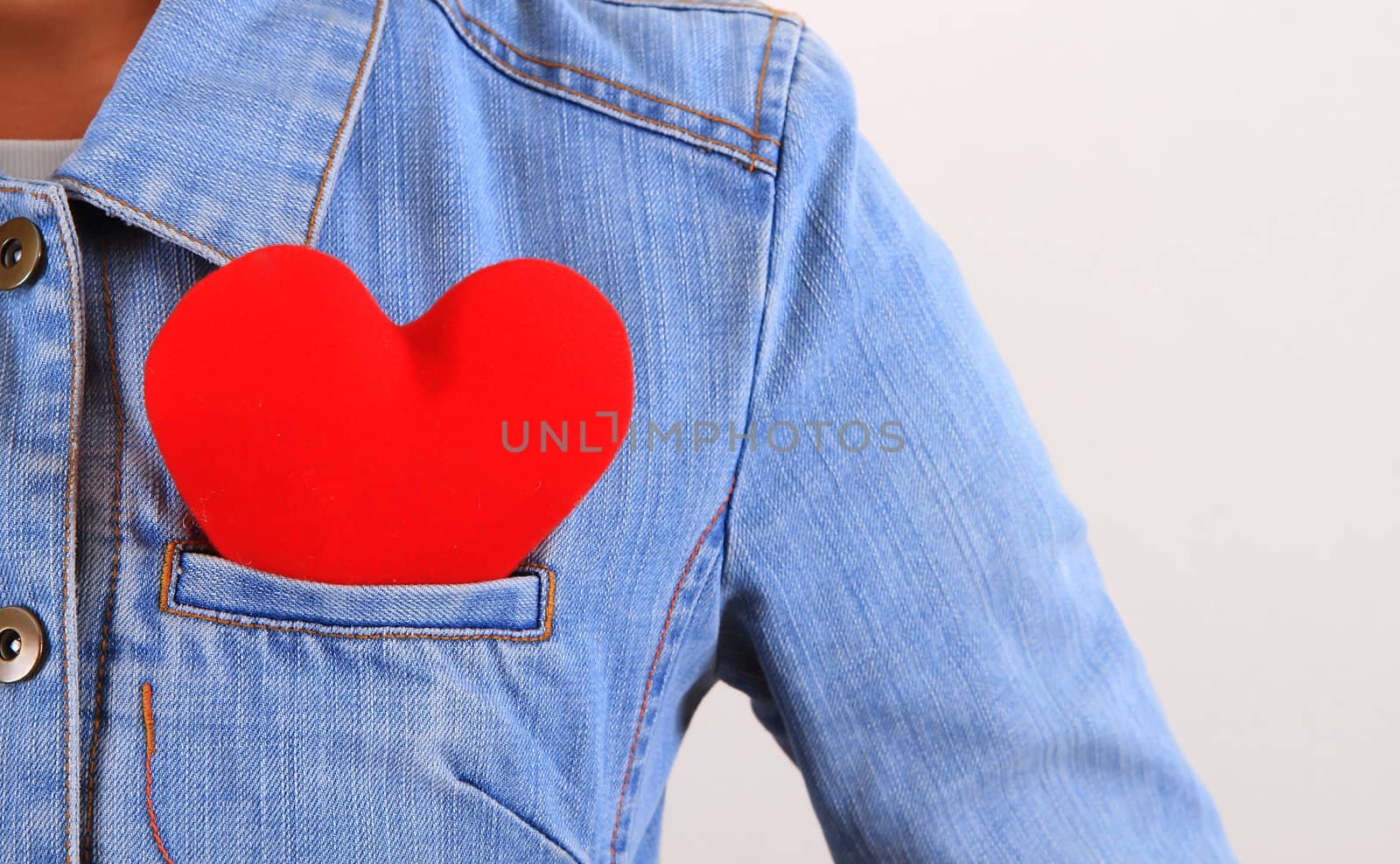 Red heart sticking out of blue jeans back pocket  by rufous