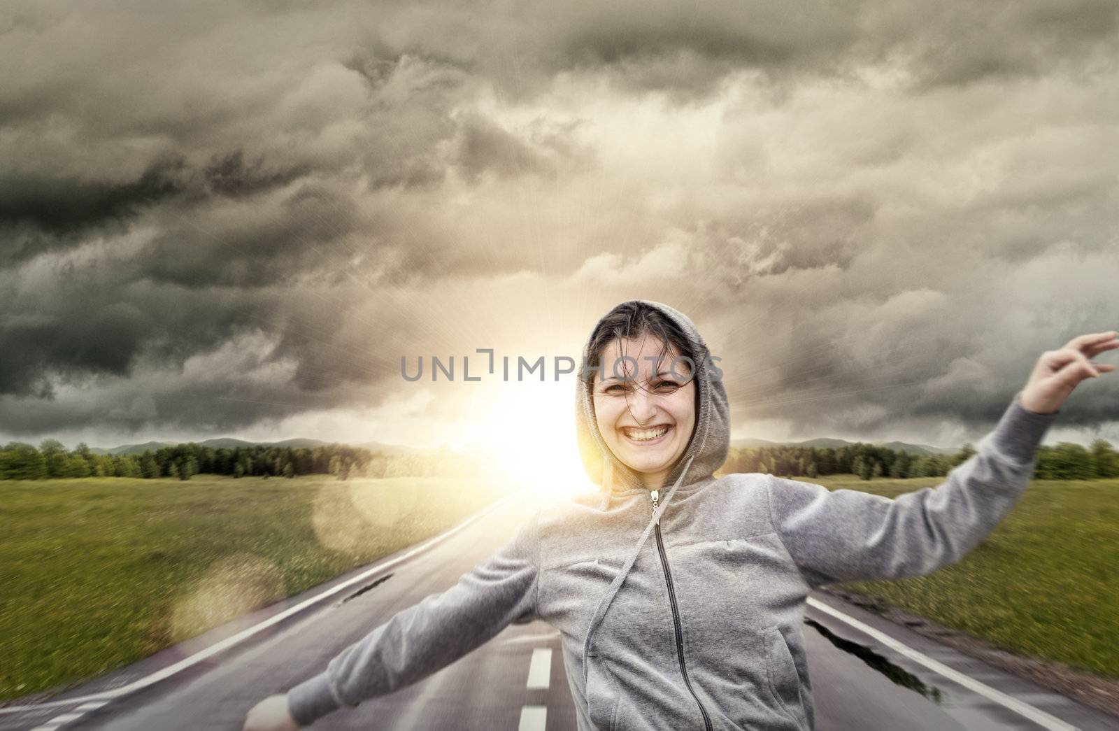 Young girl laughting and running on sunset