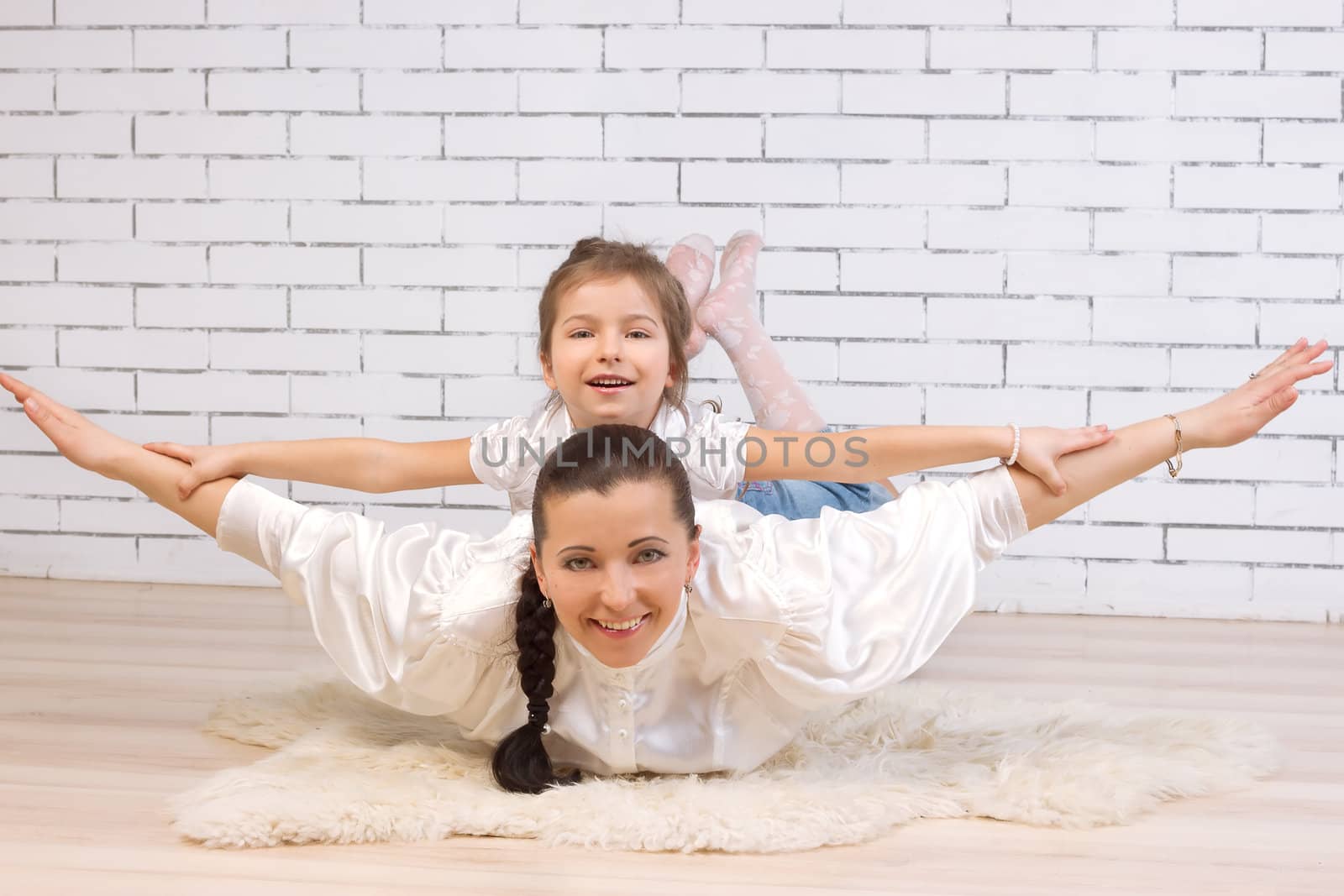 5 year old daughter riding on her mother portrayed flying against the wall