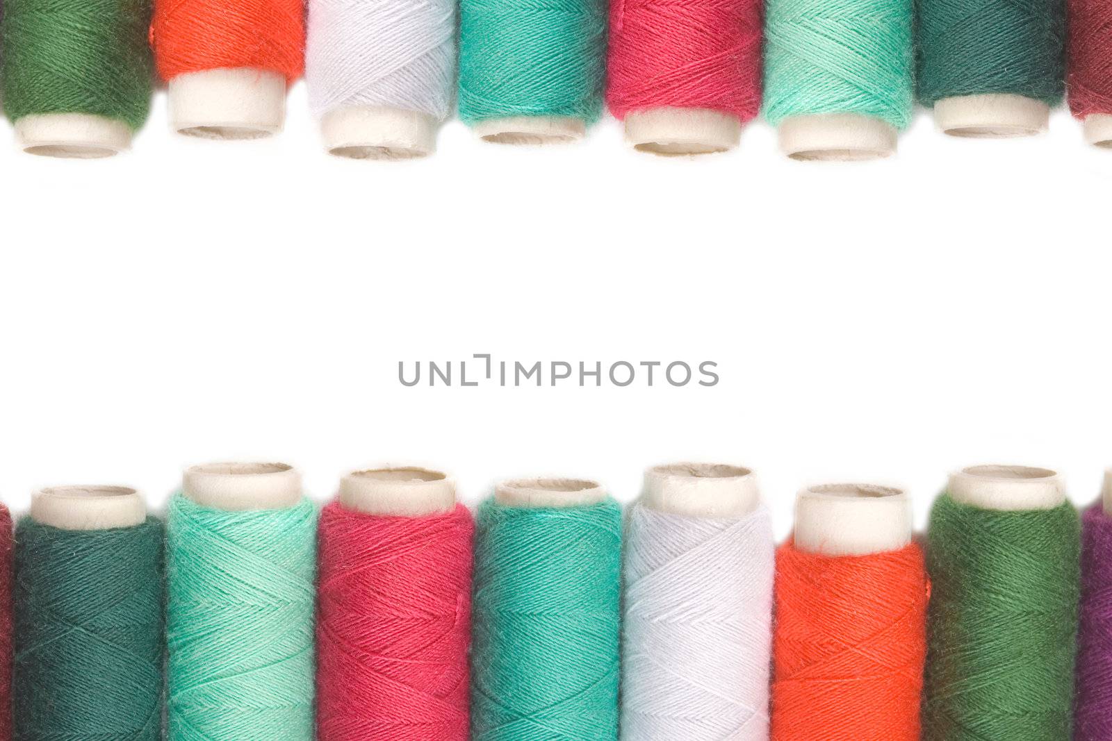 Color thread reels over white background by Carche