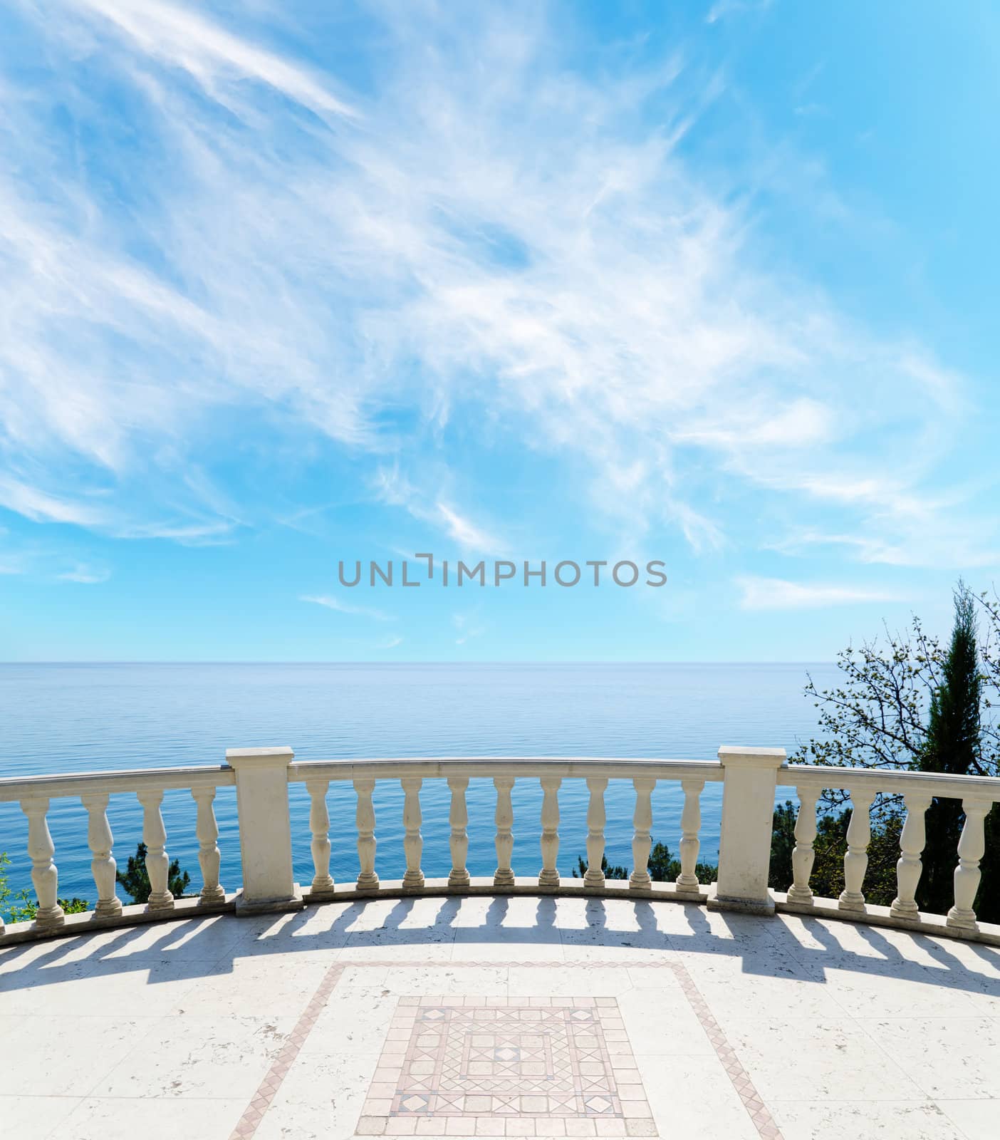 view to the sea from a balcony under cloudy sky by mycola