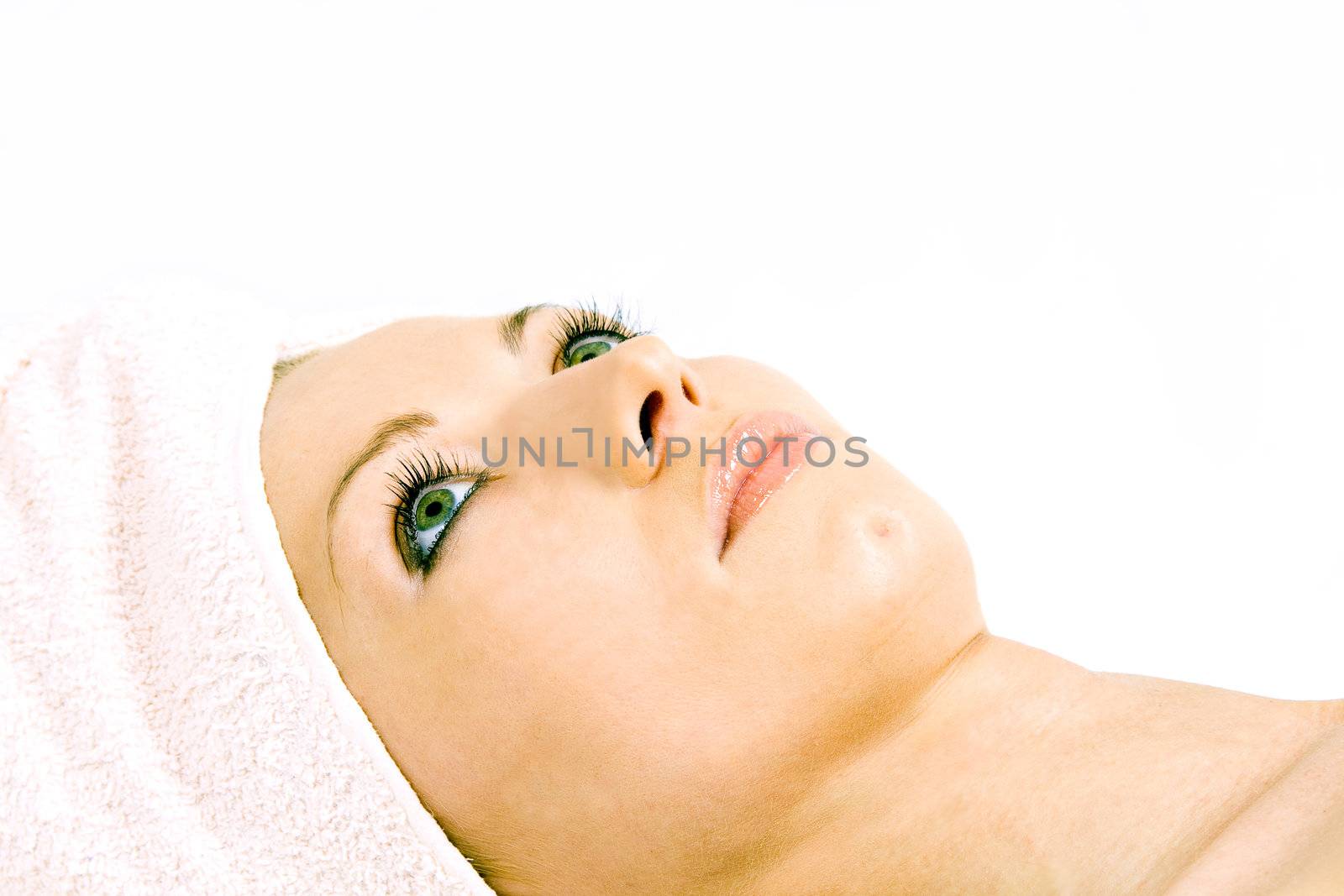 Beautiful woman during the spa treatment isolated on white.