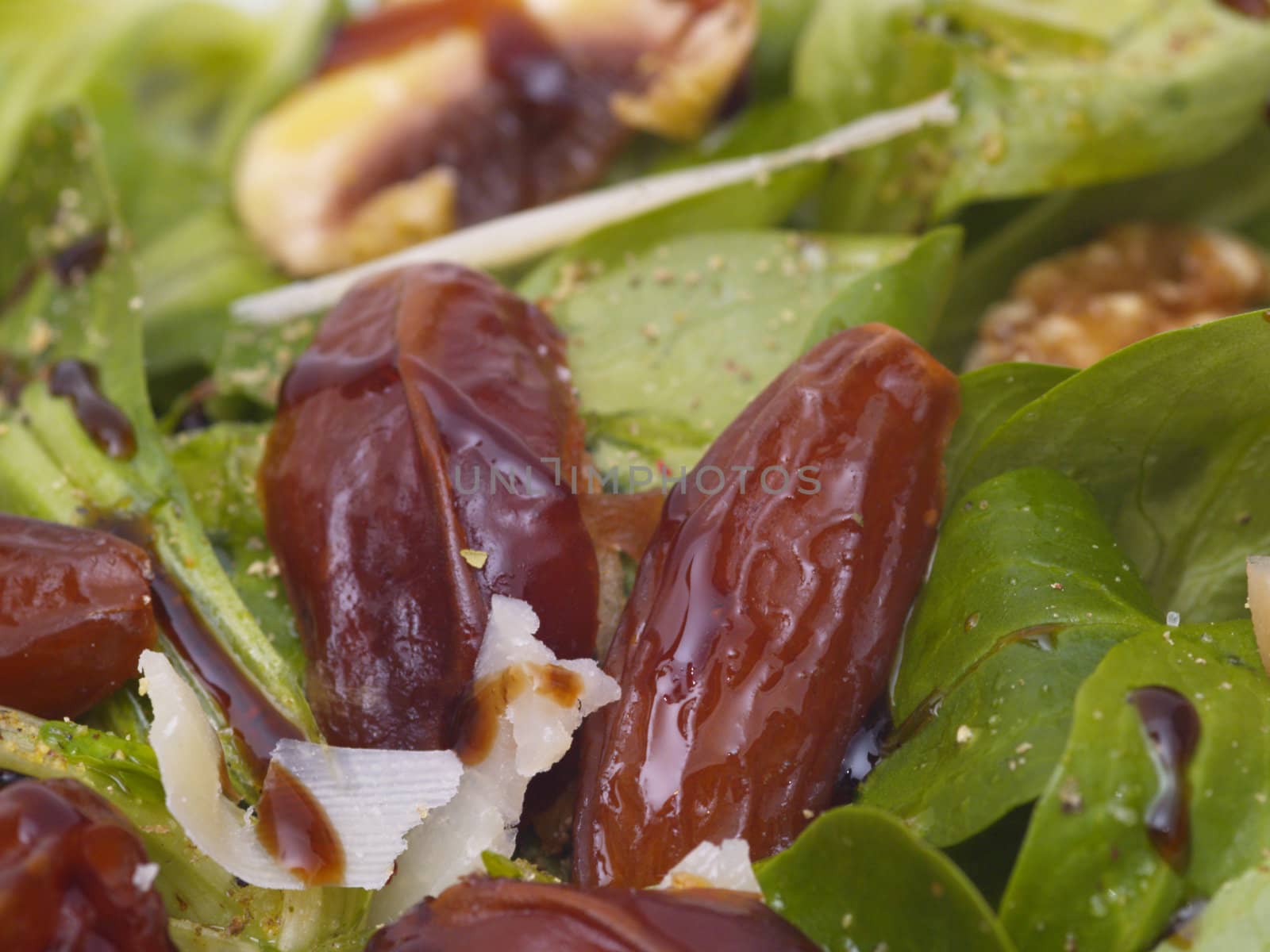 lamb's lettuce with dates, walnuts, champignos and parmesan cheese