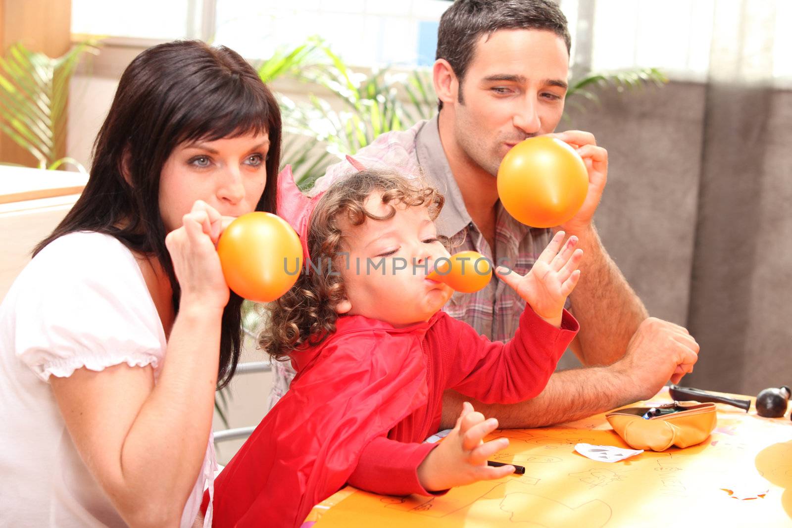 Parents and little boy preparing Halloween party