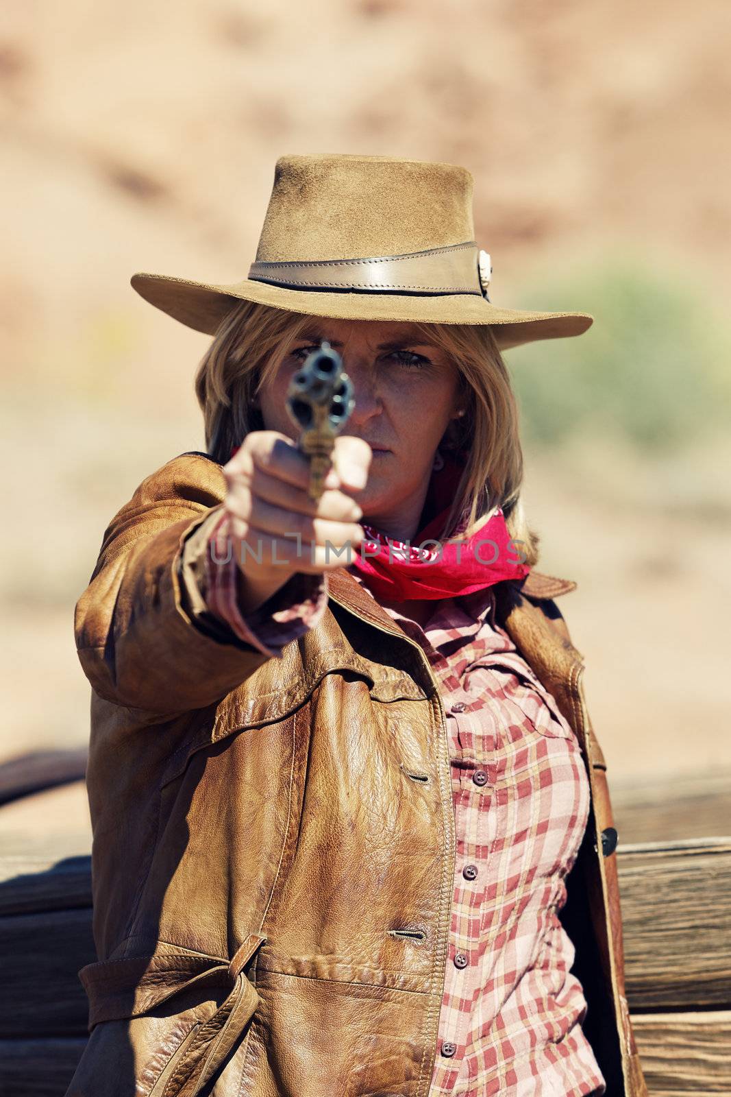 cowgirl with a gun in the hand