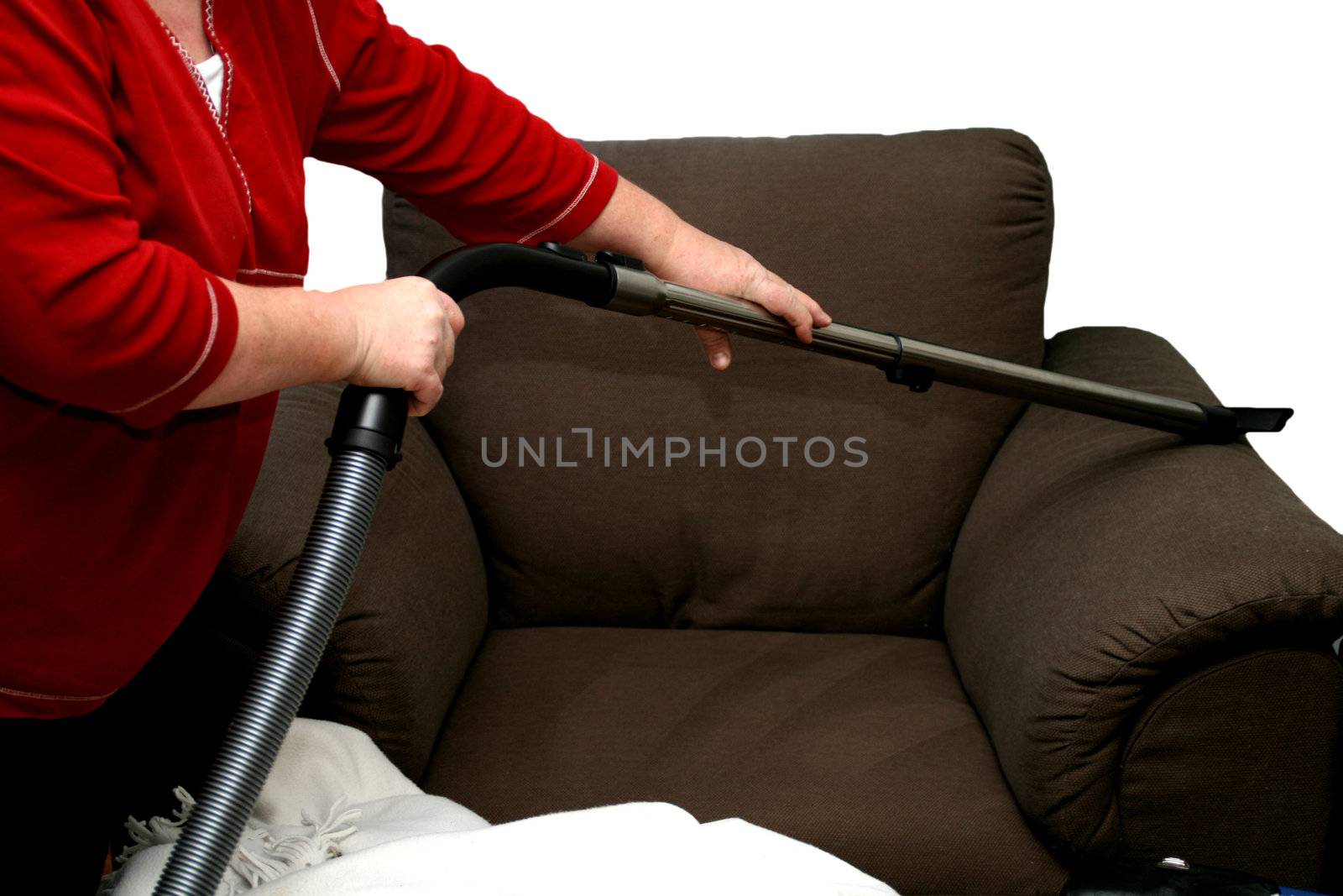 Lady cleaning chair with vacuum cleaner