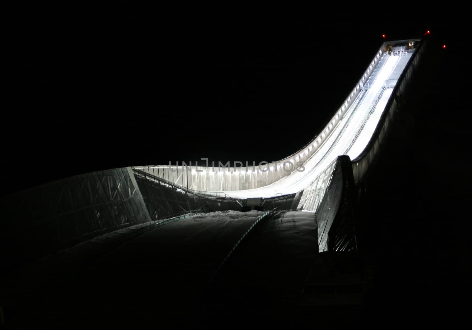 Holmenkollen ski jumping arena in Oslo at night.