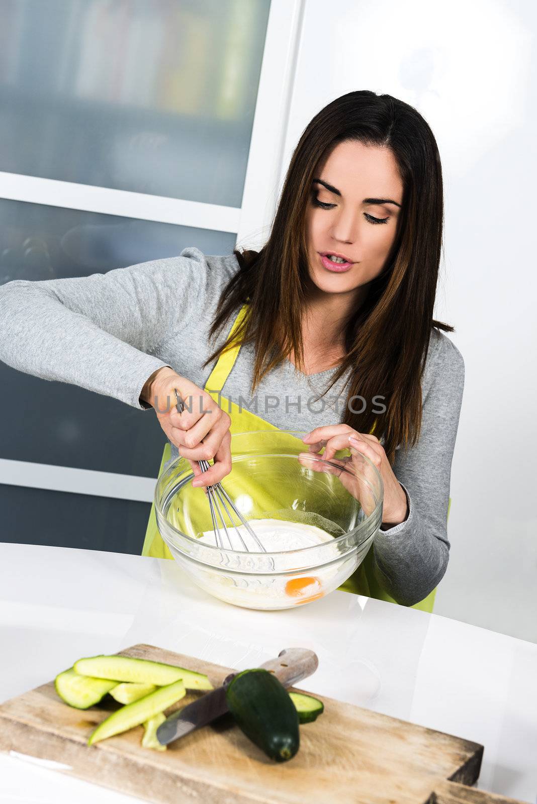 Attarctive Young woman is cooking healthy food 