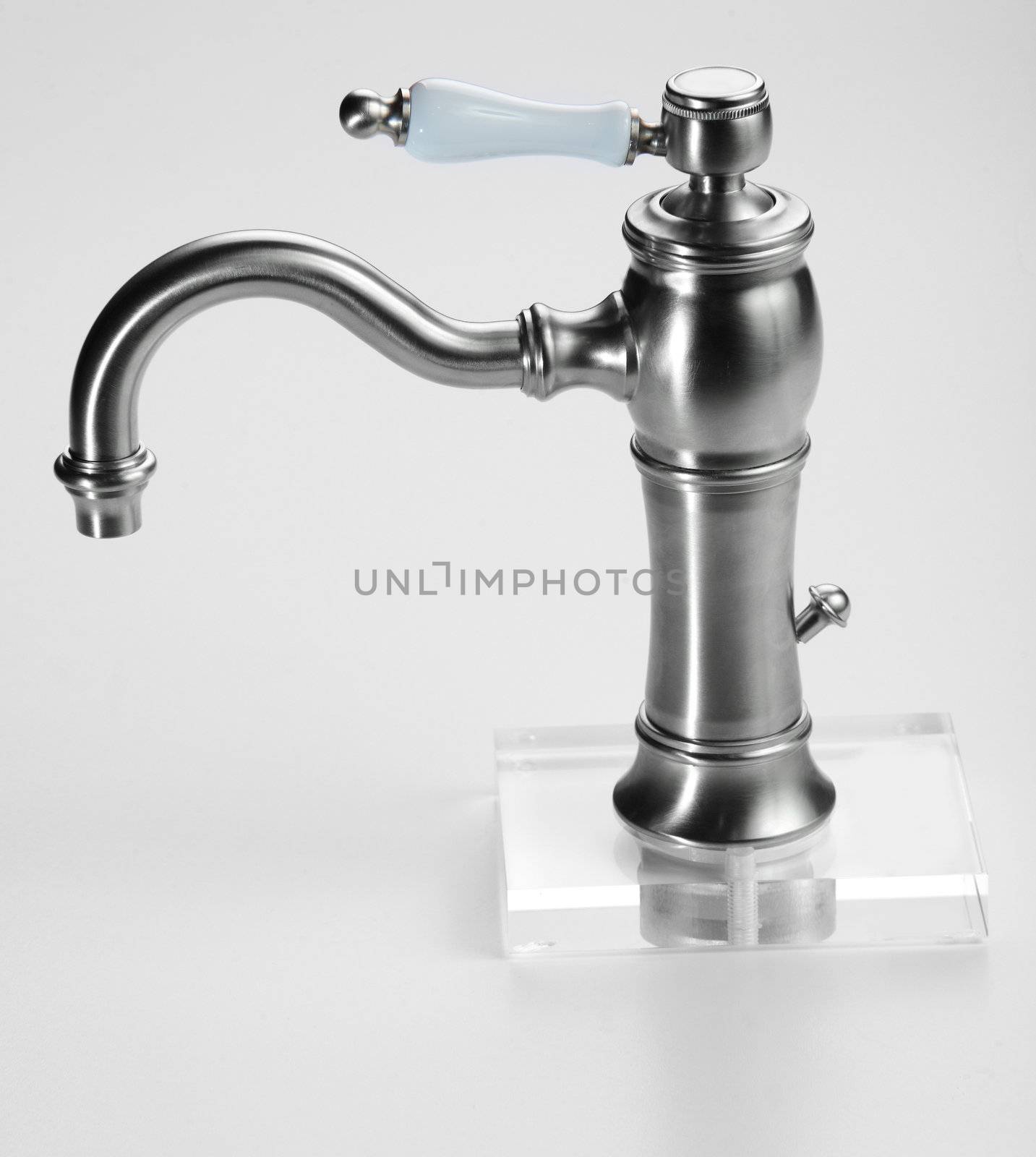 Brand new water tap on bright background