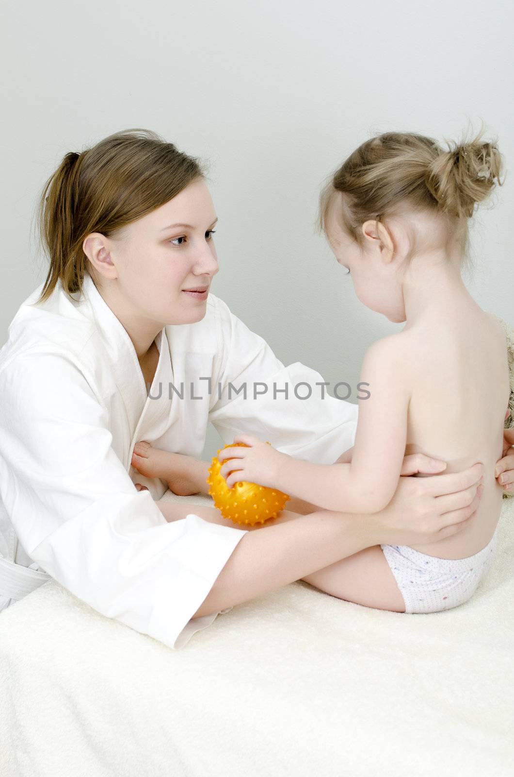 Therapist makes a child massage 