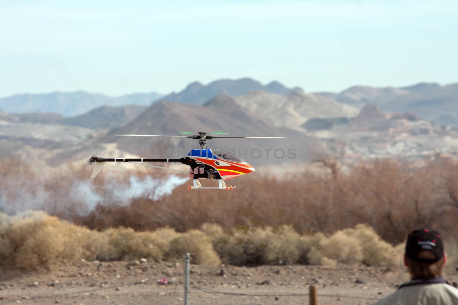 RC helicopter in flight in front of mountains