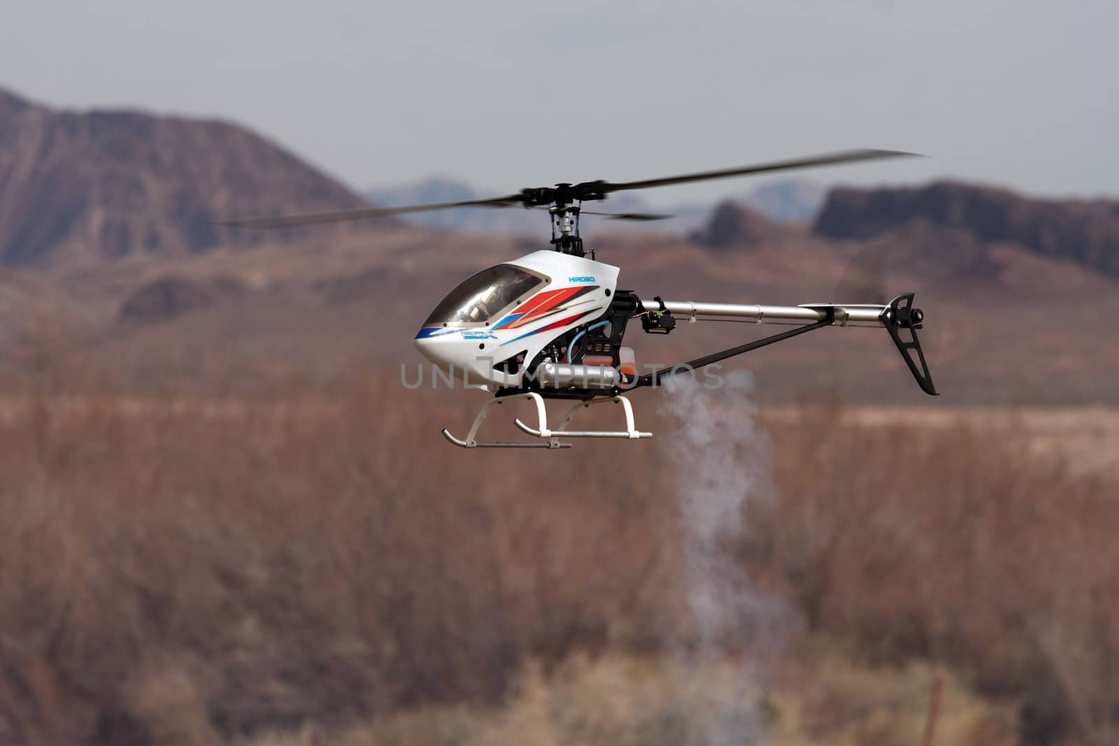 RC helicopter in flight in front of mountains