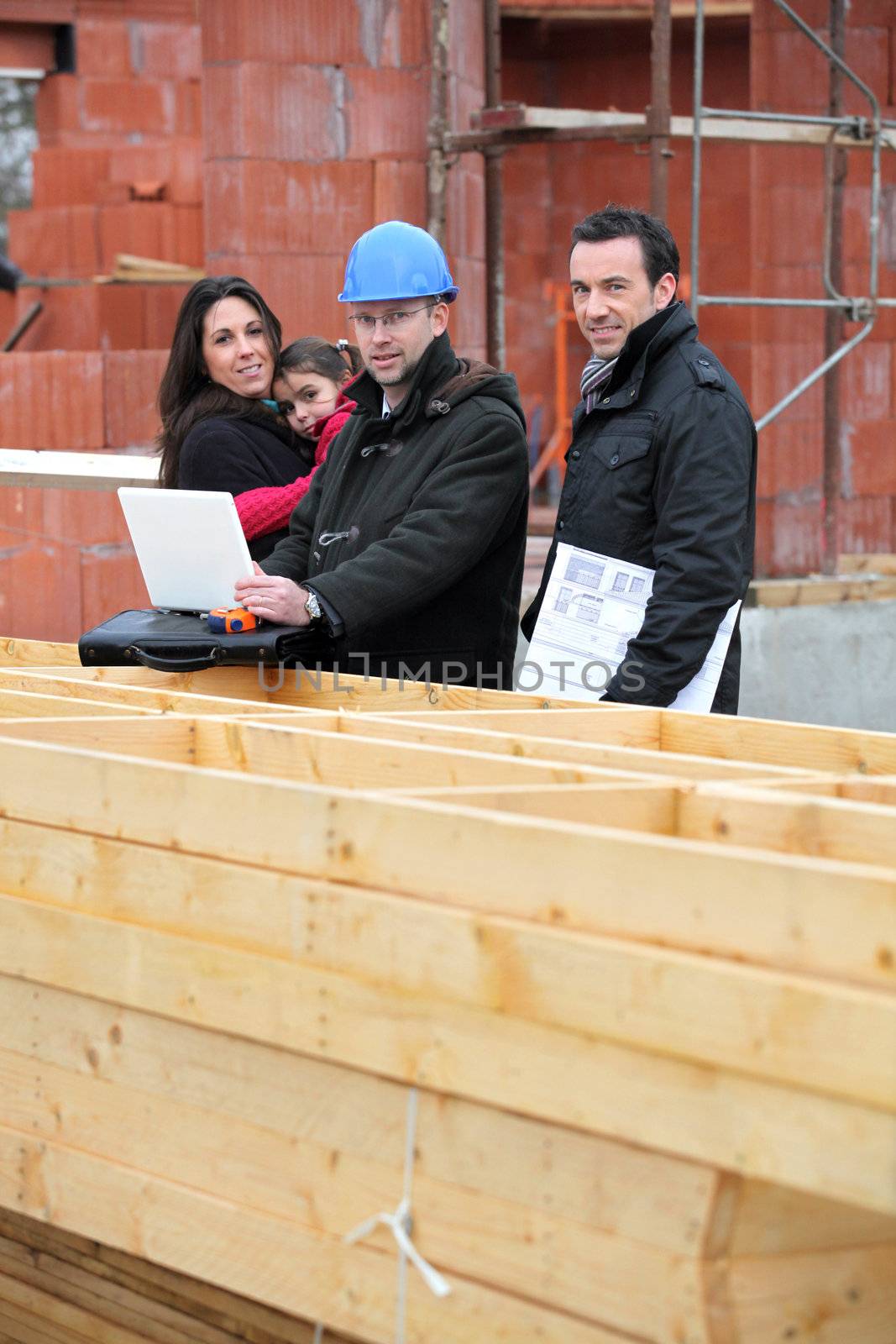 Architect with young family at construction site