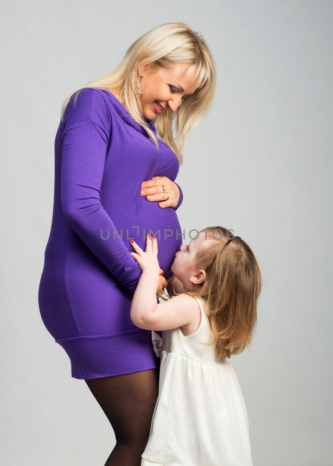 Beautiful pregnant woman with her daughter